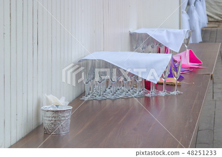 The image of many empty glasses at the champagne ready for a reception under a napkin The image of many empty glasses at the champagne ready for a reception under a napkin 48251233