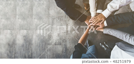Business people putting their hands together, top view Business people putting their hands together, top view 48251979