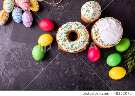 Easter cake and colorful eggs on a dark background Easter cake and colorful eggs on a dark background 48252073