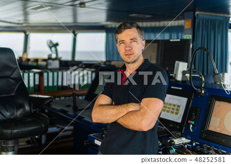 Marine navigational officer during navigational watch on Bridge Marine navigational officer during navigational watch on Bridge 48252581