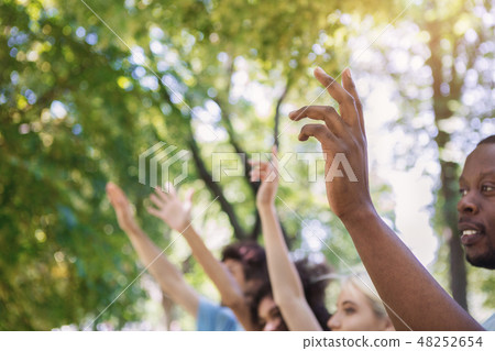 Volunteers voting at group meeting in park 48252654