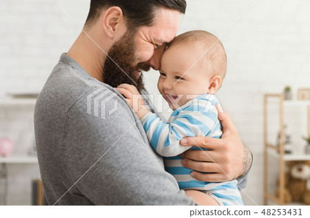 Loving father embracing his cute baby son 48253431