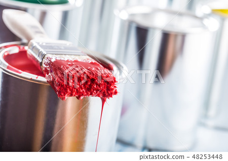 Close-up brush with red color lying on paint can. Close-up brush with red color lying on paint can. 48253448