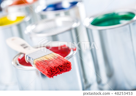 Close-up brush with red color lying on paint can. Close-up brush with red color lying on paint can. 48253453