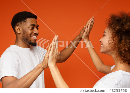 Happy black man and woman clapping their hands Happy black man and woman clapping their hands 48253768