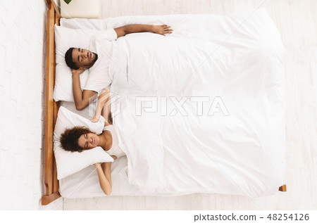 Tired and annoyed woman of her boyfriend snoring Tired and annoyed woman of her boyfriend snoring 48254126