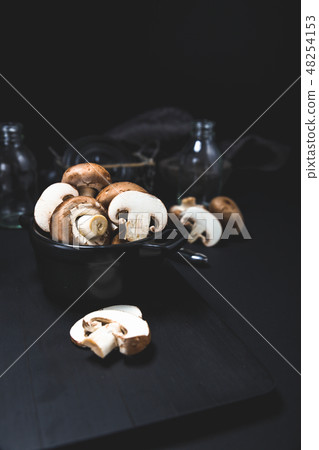 Champignon mushroom on the dark table moody 48254153