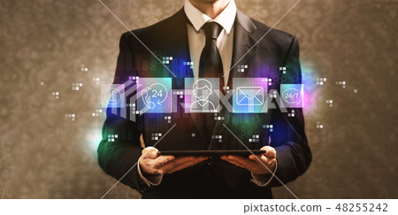 Customer service 24 hours 7 days a week with businessman holding a tablet computer  48255242