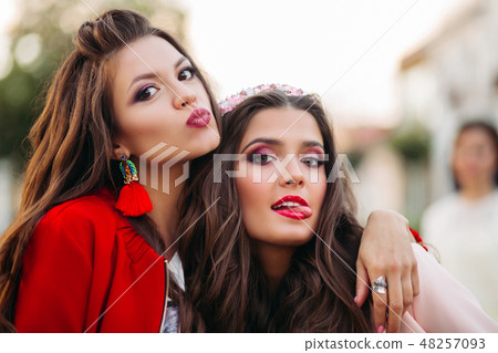 Pretty girls making faces at camera 48257093