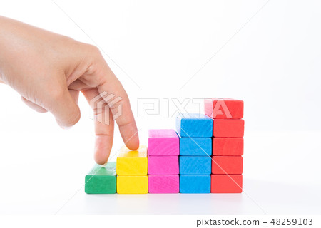 Woman hand finger walk on stacked wooden block 48259103