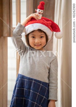 A cute kindergarten girl showing me a snowman for Christmas made with Yakult 48262900