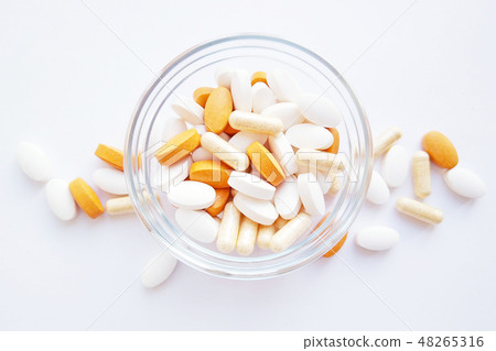 Pills and capsules in a bolw on white background Pills and capsules in a bolw on white background 48265316