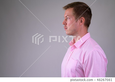 Profile view of young handsome businessman wearing pink shirt 48267081