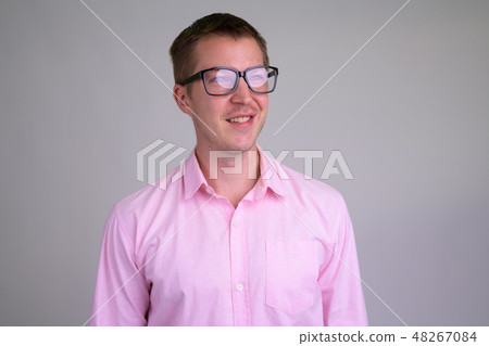 Face of happy young nerd businessman thinking with eyeglasses 48267084