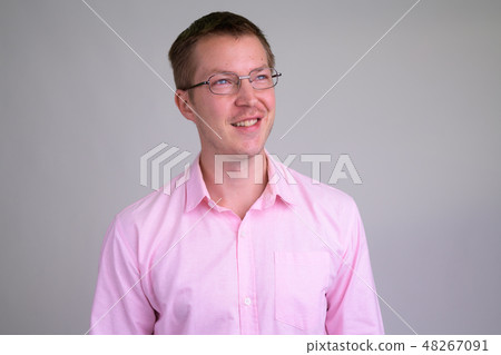 Face of young happy businessman thinking with eyeglasses Face of young happy businessman thinking with eyeglasses 48267091