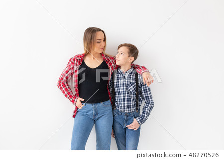 Mothers day, children and family concept - Beautiful woman and her son on white background Mothers day, children and family concept - Beautiful woman and her son on white background 48270526
