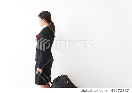 A young business woman going abroad on a business trip 48272257