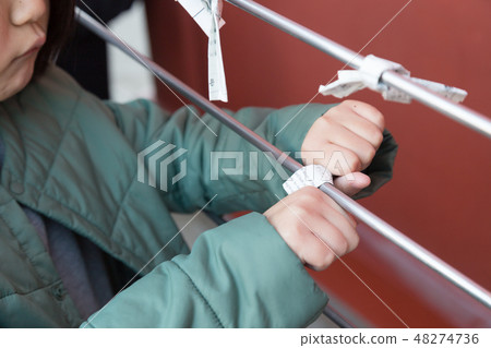 Children tying Omikuji to the precincts 48274736