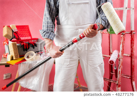 House painter at work on the construction site. House painter at work on the construction site. 48277176