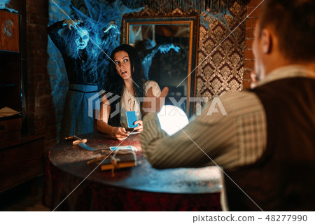 Couple on spiritual seance, witch on background 48277990