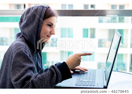 Woman Hacker programmer is working on computer in cyber security center filled with display screens Woman Hacker programmer is working on computer in cyber security center filled with display screens 48278645