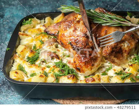 Baked chicken and cheese potatoes in cast iron.  48279511