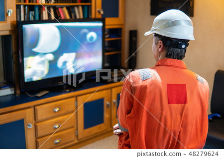 Marine chief officer having fun watching TV Marine chief officer having fun watching TV 48279624