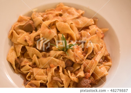 Pappardelle pasta with meat and cheese sauce. Pappardelle pasta with meat and cheese sauce. 48279887