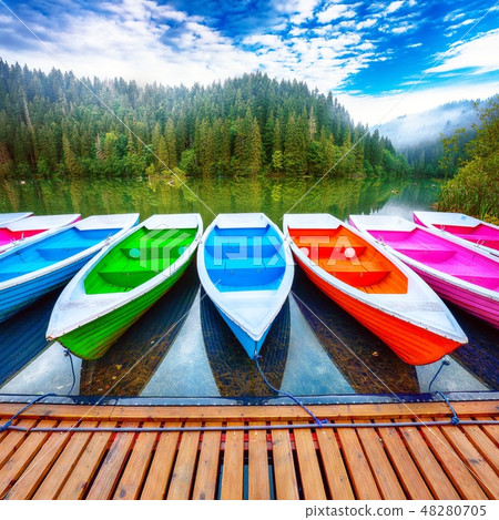 Boats on majestic mountain lake Lacul Rosu Boats on majestic mountain lake Lacul Rosu 48280705