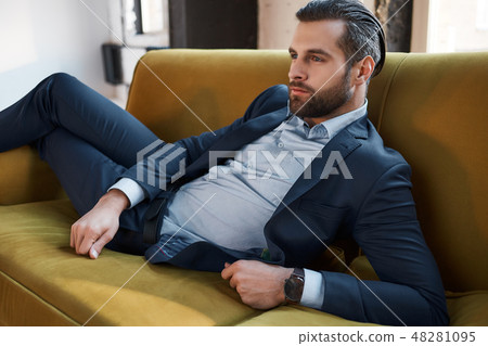 Stylish young man in a suit and bow tie. Business style. Fashionable image. 48281095