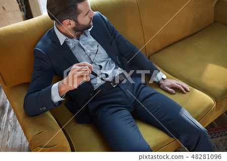 Stylish young man in a suit and bow tie. Business style. Fashionable image. Evening dress. 48281096