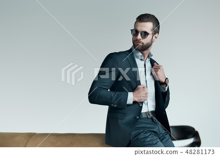 Stylish young man in a suit and bow tie. Business style. Fashionable image. Evening dress. Sexy man 48281173