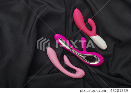 Stimulate your most sensitive area. Composition of colorful G-spot vibrators arranged on a black 48281289