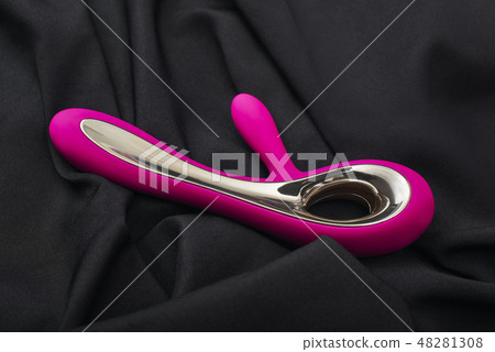 Discover yourself. Close up photo of purple silicone G-spot vibrator for her on a black silk fabric. Discover yourself. Close up photo of purple silicone G-spot vibrator for her on a black silk fabric. 48281308