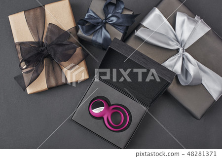 Special gift for her...Pink clitoris vibrator for women and couples in a black box laying against 48281371