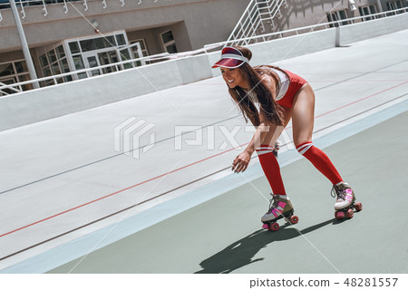 Don't be a hater, be a roller skater Beautiful woman is listening to music, skating at the skatepark Don't be a hater, be a roller skater Beautiful woman is listening to music, skating at the skatepark 48281557