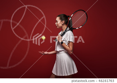 Talk with your raquet, play with your heart. Young tennis player standing isolated over red Talk with your raquet, play with your heart. Young tennis player standing isolated over red 48281763