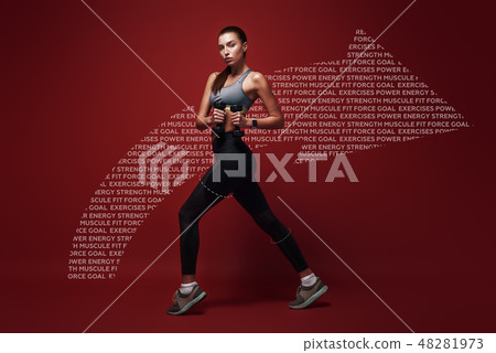 Celebrating health. Sportswoman standing over red background with dumbbells in her hands 48281973