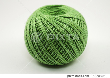 a skein of green wool on a white 48283030