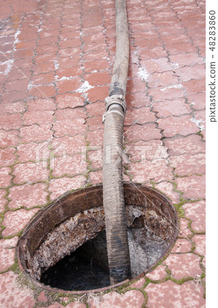 pumping sewage from the drain hole 48283860