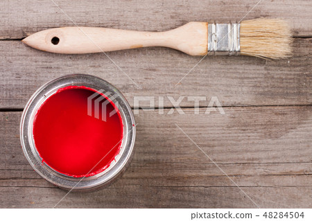 red paint in the bank to repair and brush on the old wooden background with copy space for your text 48284504