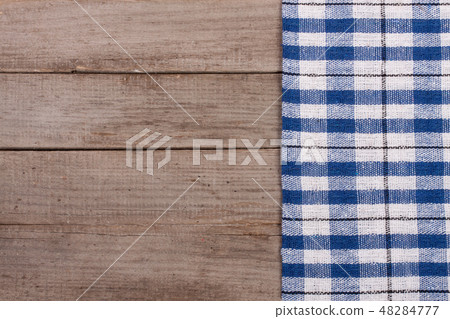 blue checkered tablecloth on an old wooden table with copy space for your text. Top view 48284777