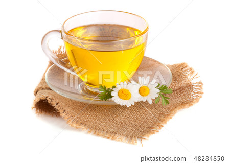 Herbal tea with fresh chamomile flowers on sackcloth isolated on white background Herbal tea with fresh chamomile flowers on sackcloth isolated on white background 48284850