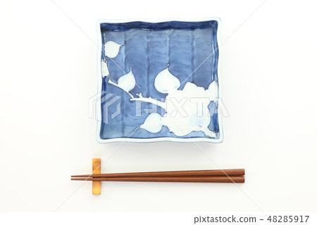 Square plates and chopsticks placed on a white table 48285917