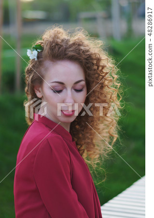 Girl with curly hair. Springtime Girl with curly hair. Springtime 48286917