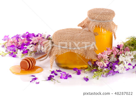 Jar of honey with wildflowers isolated on white background 48287022