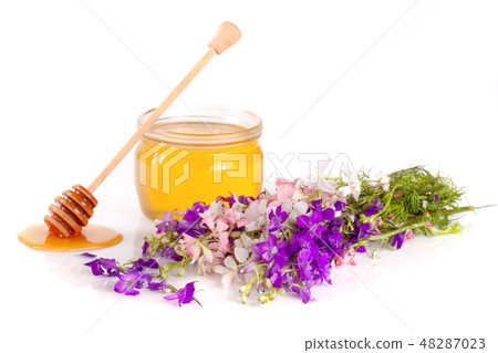 Jar of honey with wildflowers isolated on white background 48287023