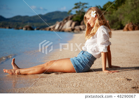 Beautiful Girl in sea style sitting on sand. Travel and Vacation. Freedom Concept.  48290067