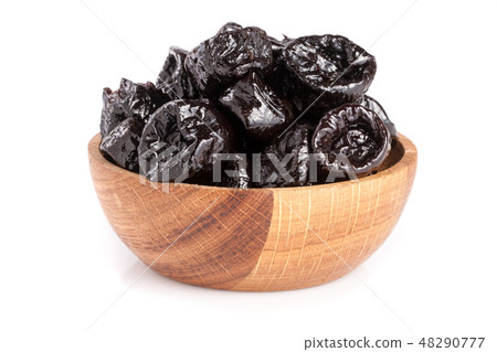Dried plums or prunes in wooden bowl isolated on white background Dried plums or prunes in wooden bowl isolated on white background 48290777