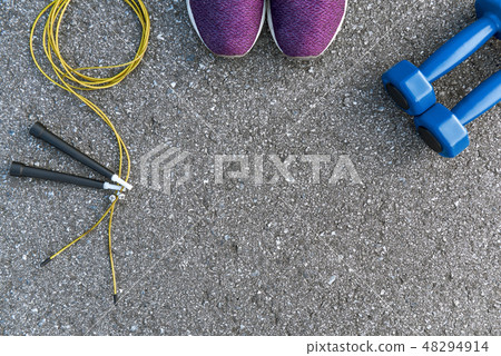 Jump rope near sports items and sport shoes. Jump rope near sports items and sport shoes. 48294914